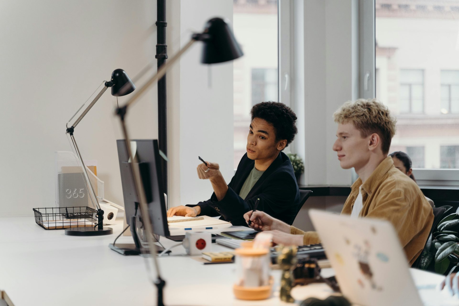 A diverse group of professionals engaging in teamwork in a modern office environment.
