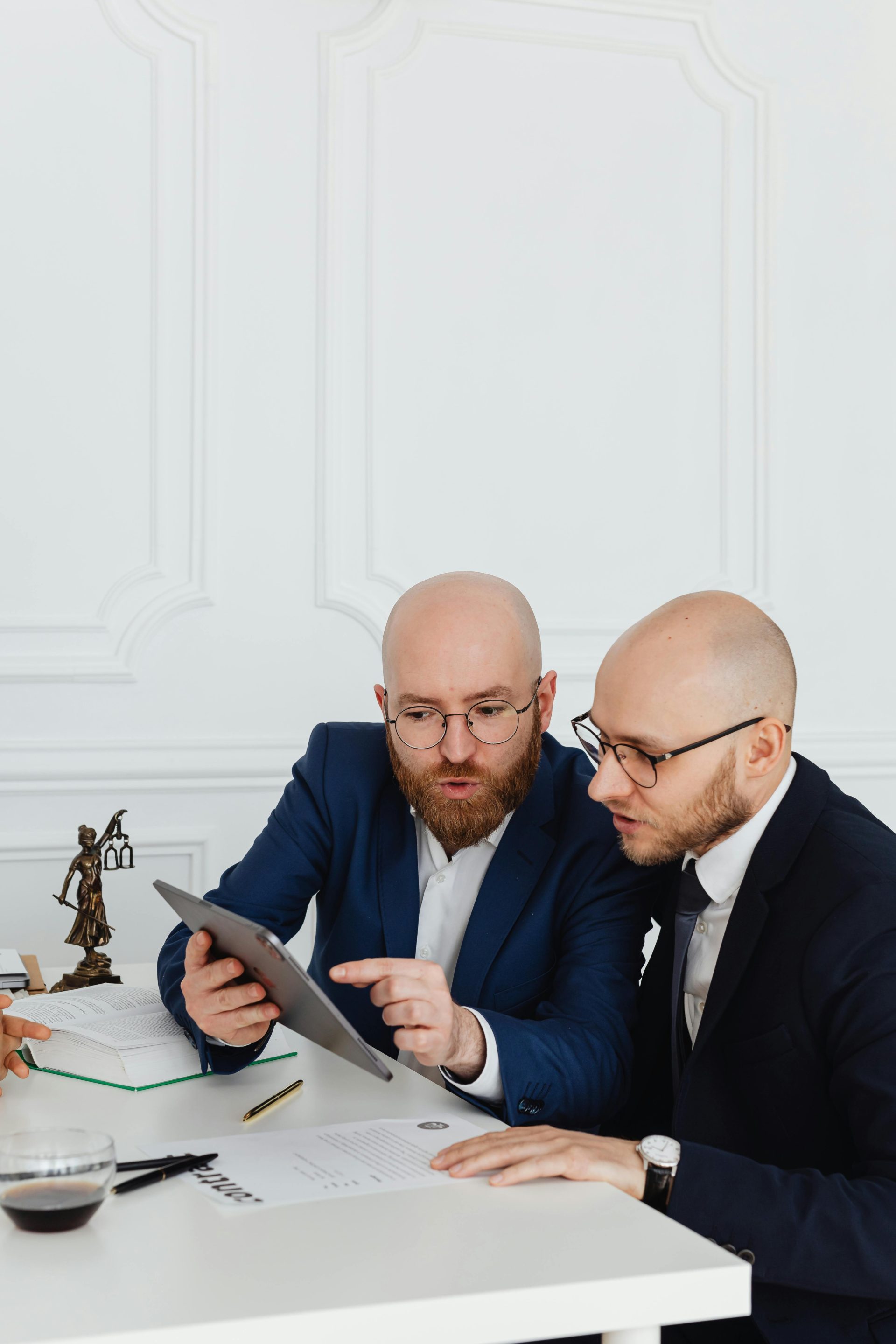 Zwei Fachleute unterhalten sich während einer Geschäftsbesprechung in einem Büro mithilfe eines digitalen Tablets.